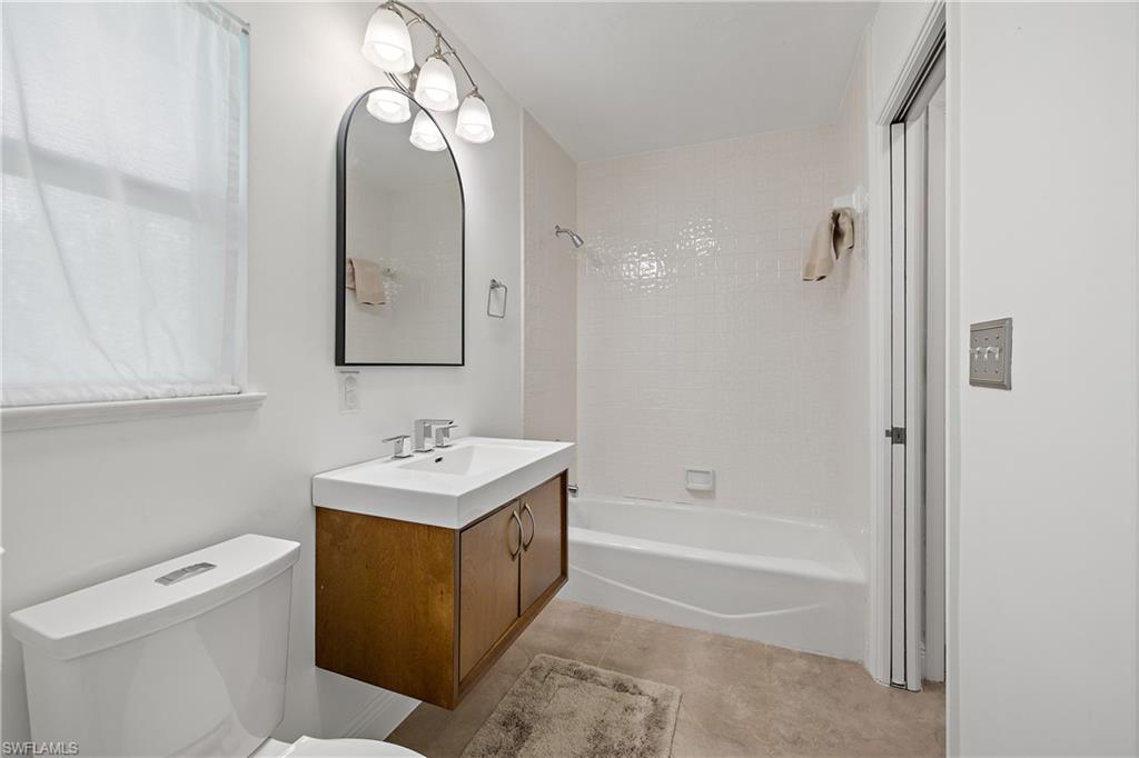 540 Rudder Road Naples, FL 34102 - Photo 21 of 37 Bathroom with toilet, tile patterned floors, vanity, and washtub / shower combination