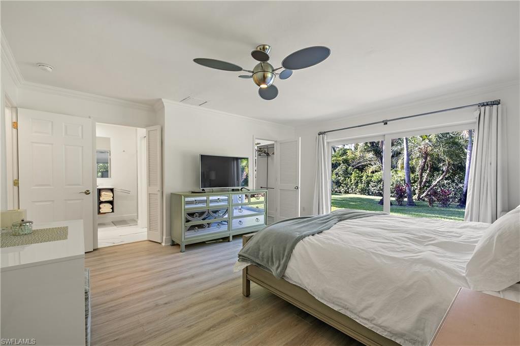 540 Rudder Road Naples, FL 34102 - Photo 25 of 37 Bedroom featuring light wood finished floors, access to exterior, crown molding, and ceiling fan