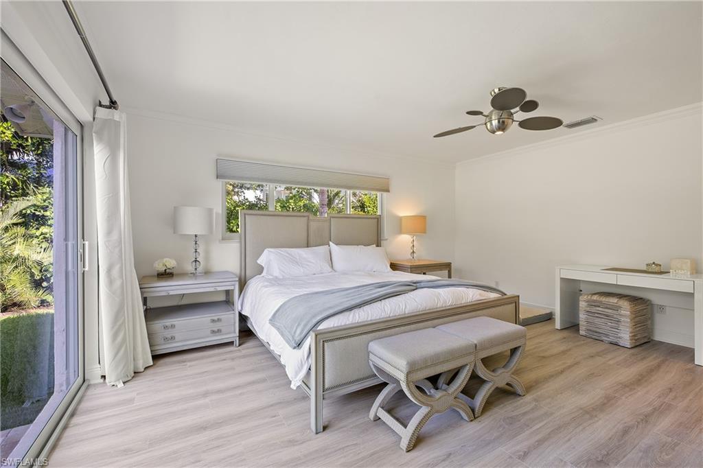 540 Rudder Road Naples, FL 34102 - Photo 26 of 37 Bedroom featuring light wood-style flooring, crown molding, and visible vents