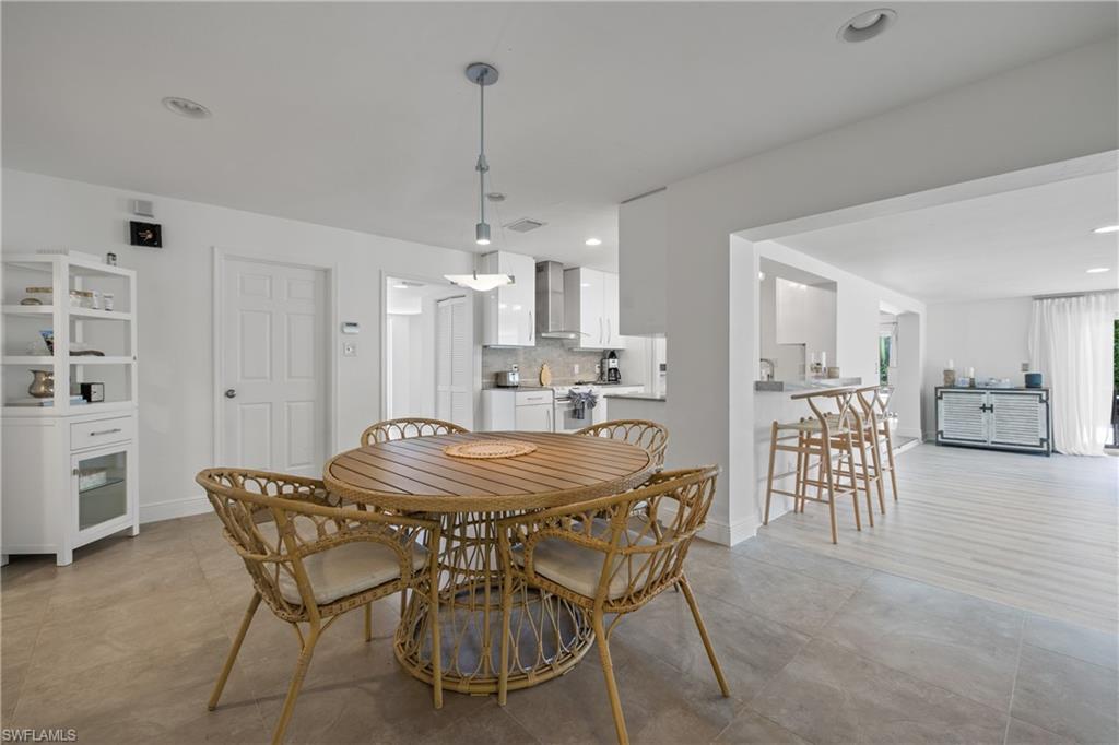 540 Rudder Road Naples, FL 34102 - Photo 31 of 37 Dining room with baseboards, recessed lighting, and light tile patterned floors