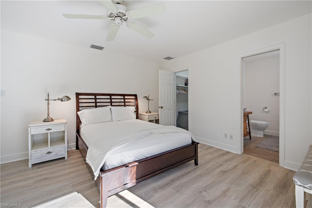 540 Rudder Road Naples, FL 34102 - Photo 34 of 37 Bedroom with baseboards, visible vents, and light wood-style floors