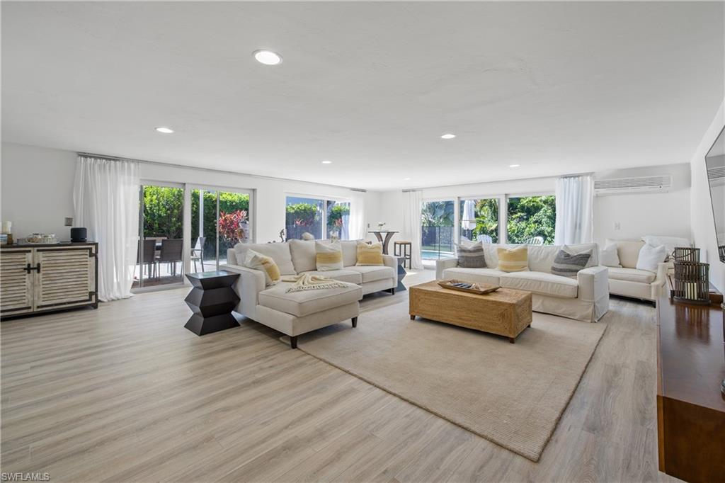 540 Rudder Road Naples, FL 34102 - Photo 6 of 37 Living area with recessed lighting, an AC wall unit, and light wood finished floors