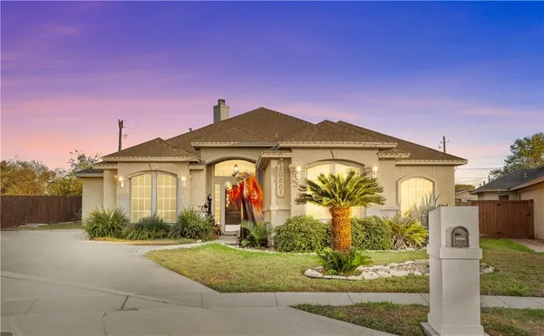 a front view of a house with garden