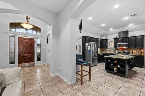 a view of kitchen with furniture and refrigerator