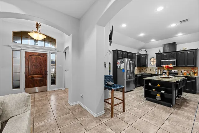 a view of kitchen with furniture and refrigerator