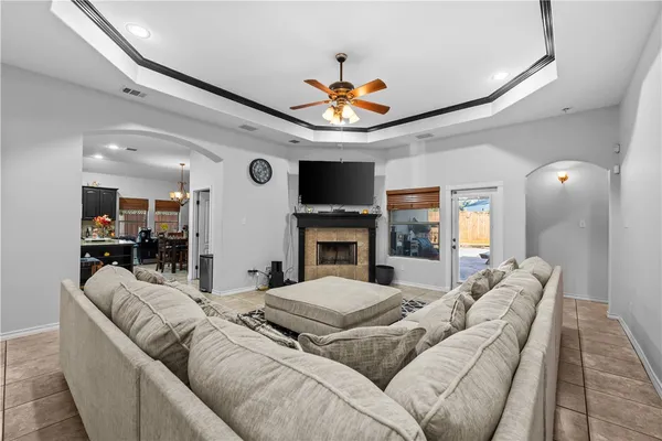 a living room with furniture a fireplace and a flat screen tv
