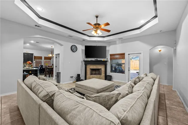 a living room with furniture a fireplace and a flat screen tv