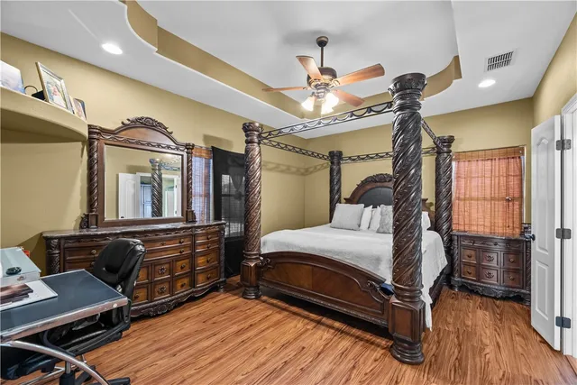 a bedroom with a bed and wooden floor