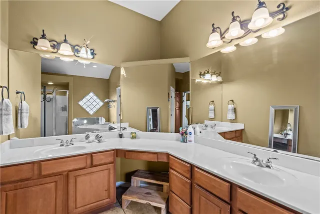 a bathroom with a double vanity sink and a mirror