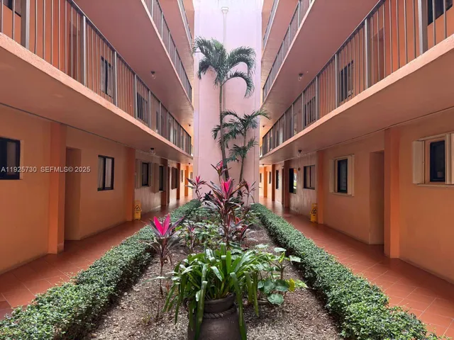 a view of a building with a lot of flower plants
