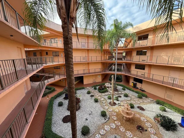 a outdoor space with a barbeque oven and glass door