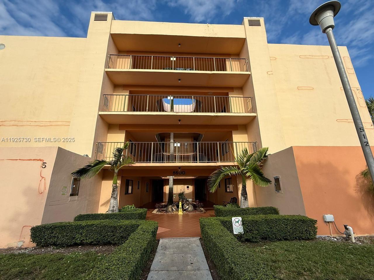 8600 Southwest 133rd Avenue Road, Unit 310 Miami, FL 33183 - Photo 14 of 22 a front view of a house with a yard