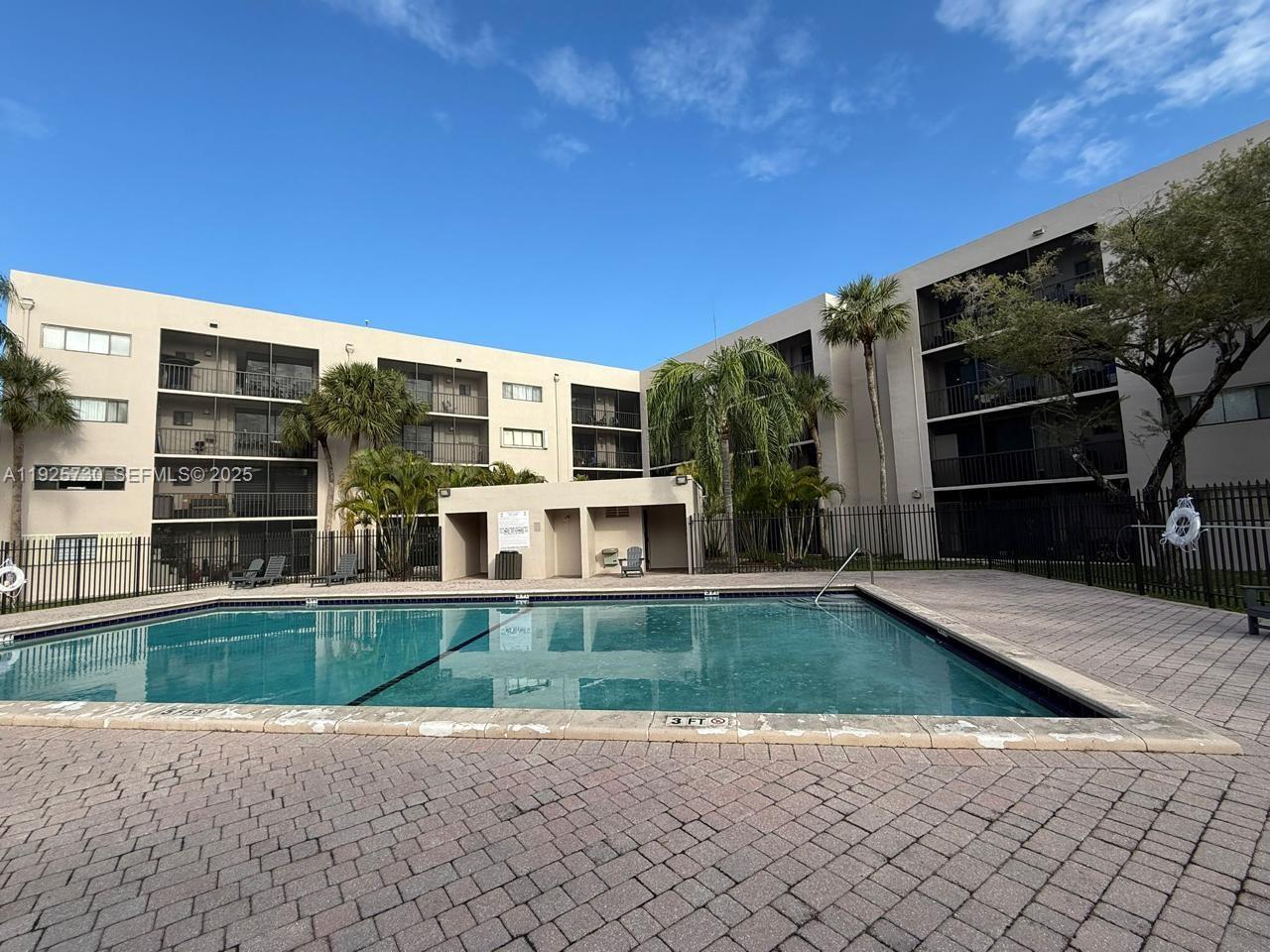 8600 Southwest 133rd Avenue Road, Unit 310 Miami, FL 33183 - Photo 21 of 22 a view of a house with backyard porch and wooden fence