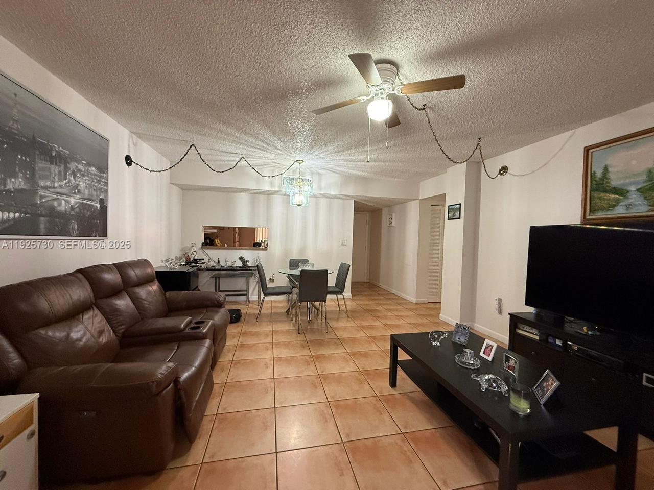 8600 Southwest 133rd Avenue Road, Unit 310 Miami, FL 33183 - Photo 7 of 22 a living room with furniture and a flat screen tv