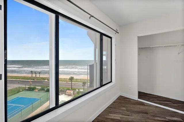 an empty room with wooden floor and door