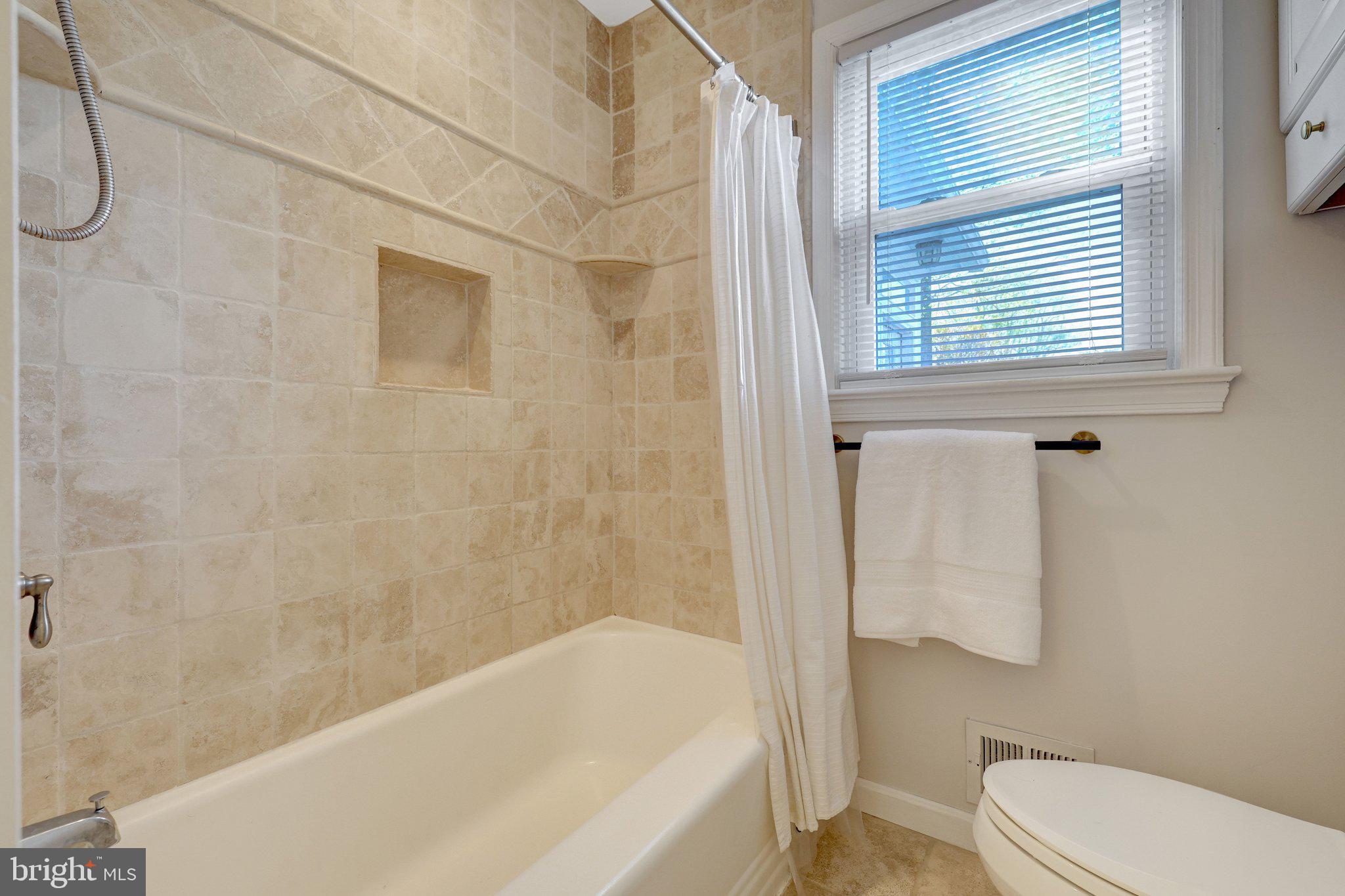 4132 Addison Road Fairfax, VA 22030 - Photo 14 of 58 a bathroom with a bathtub and shower