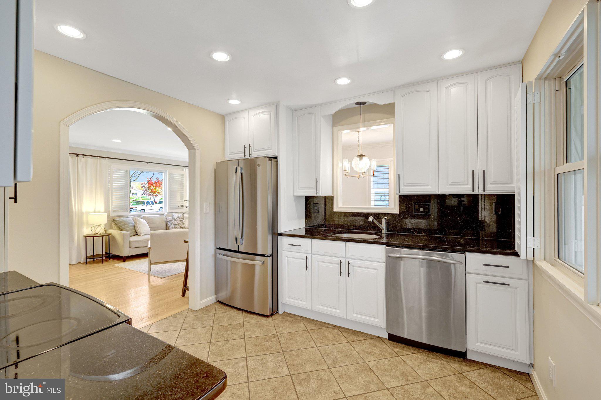 4132 Addison Road Fairfax, VA 22030 - Photo 19 of 58 a large kitchen with stainless steel appliances a refrigerator a sink dishwasher with a stove and white cabinets