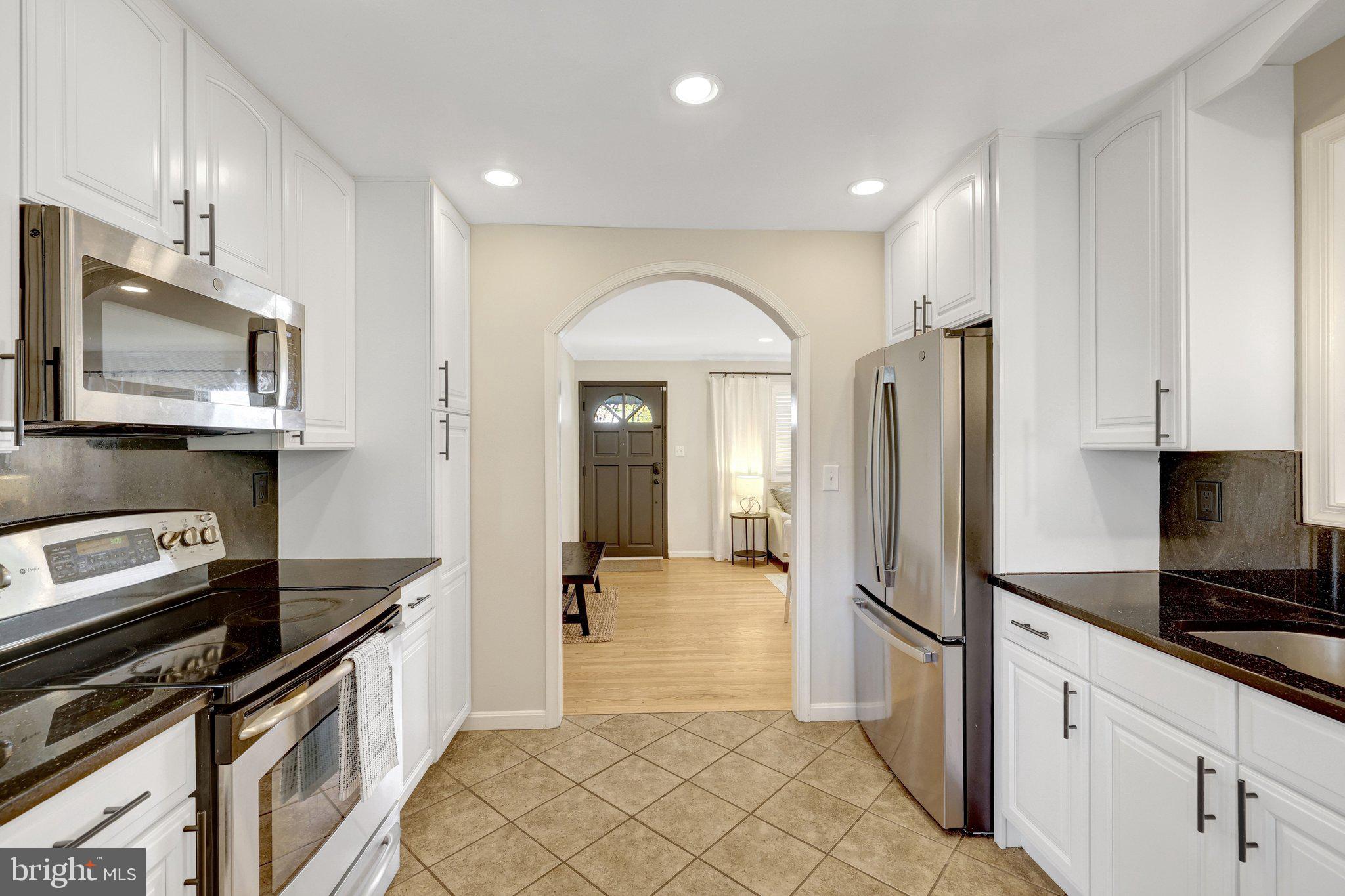 4132 Addison Road Fairfax, VA 22030 - Photo 20 of 58 a kitchen with stainless steel appliances granite countertop a refrigerator a stove and a sink