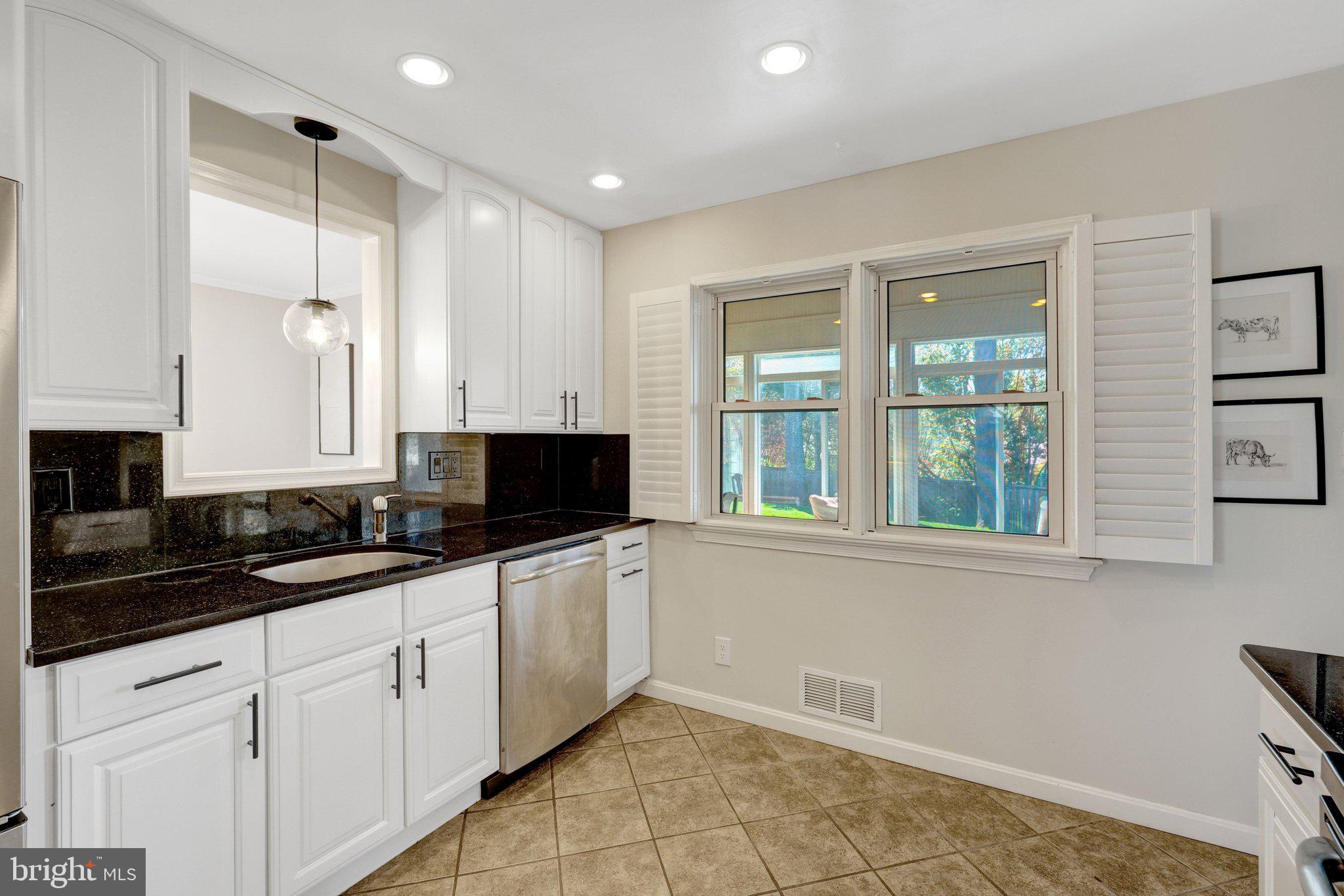 4132 Addison Road Fairfax, VA 22030 - Photo 21 of 58 a kitchen with granite countertop white cabinets and a sink