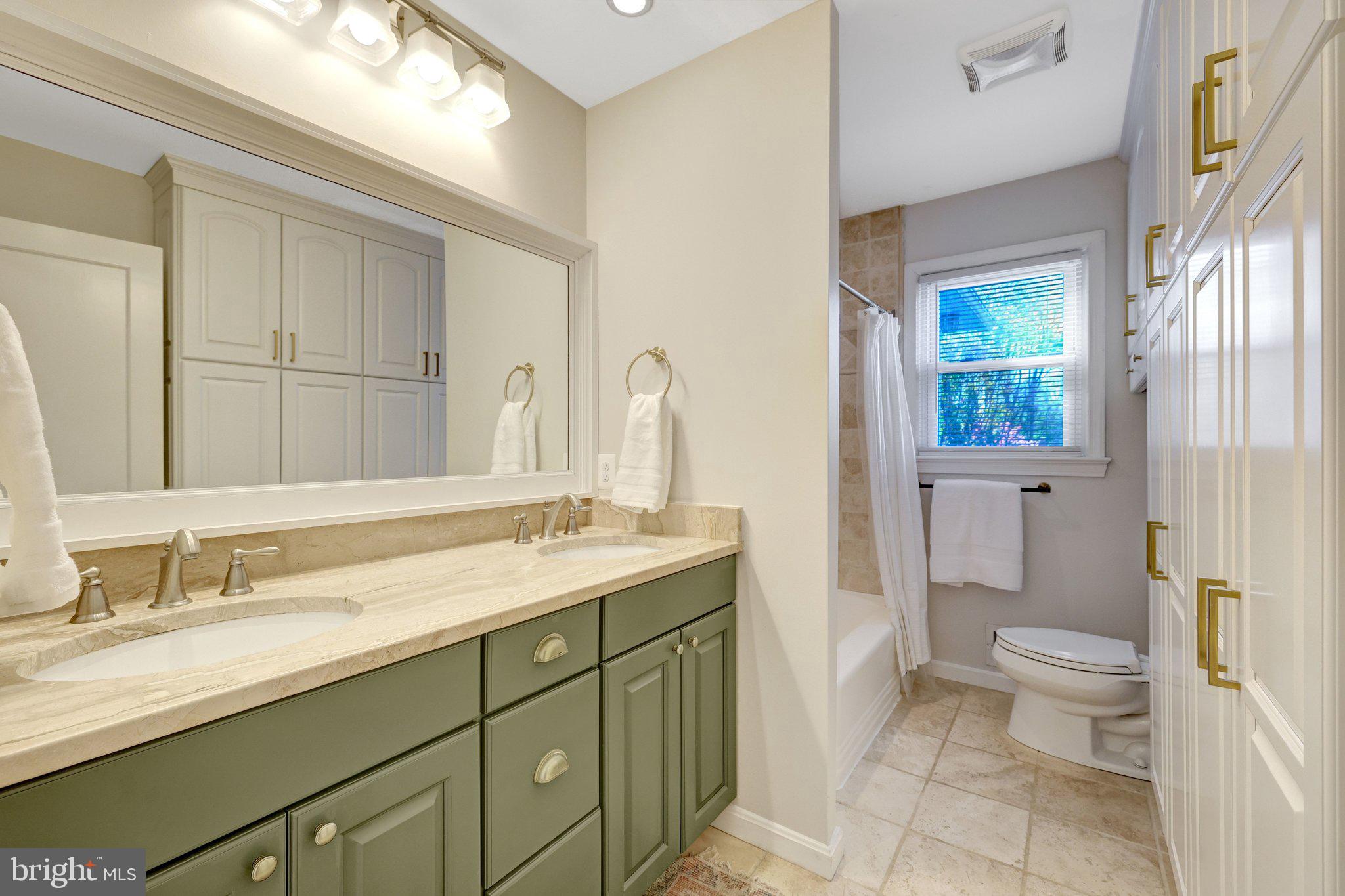 4132 Addison Road Fairfax, VA 22030 - Photo 30 of 58 a bathroom with a granite countertop sink toilet and shower