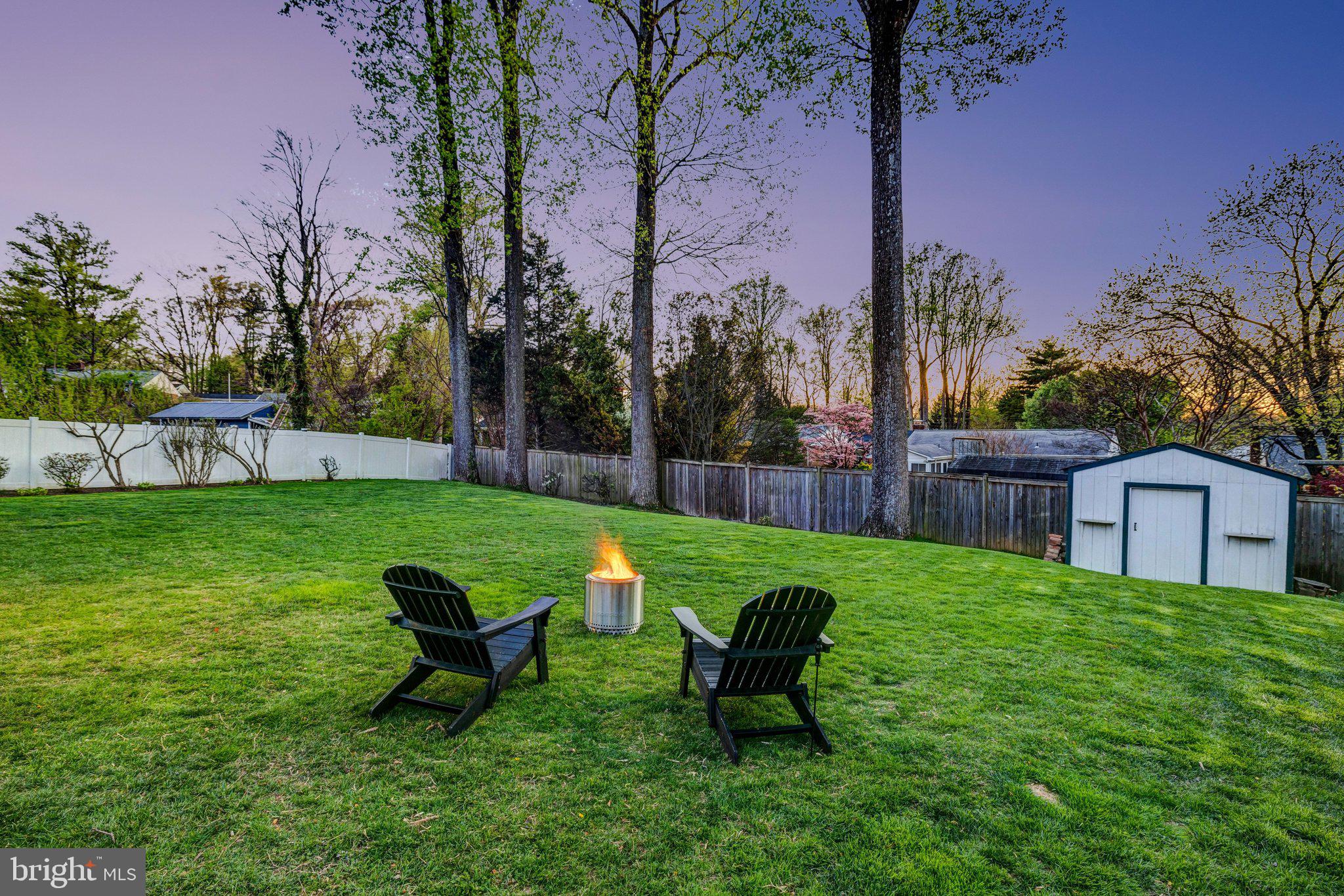 4132 Addison Road Fairfax, VA 22030 - Photo 6 of 58 a view of a backyard with table and chairs and wooden fence