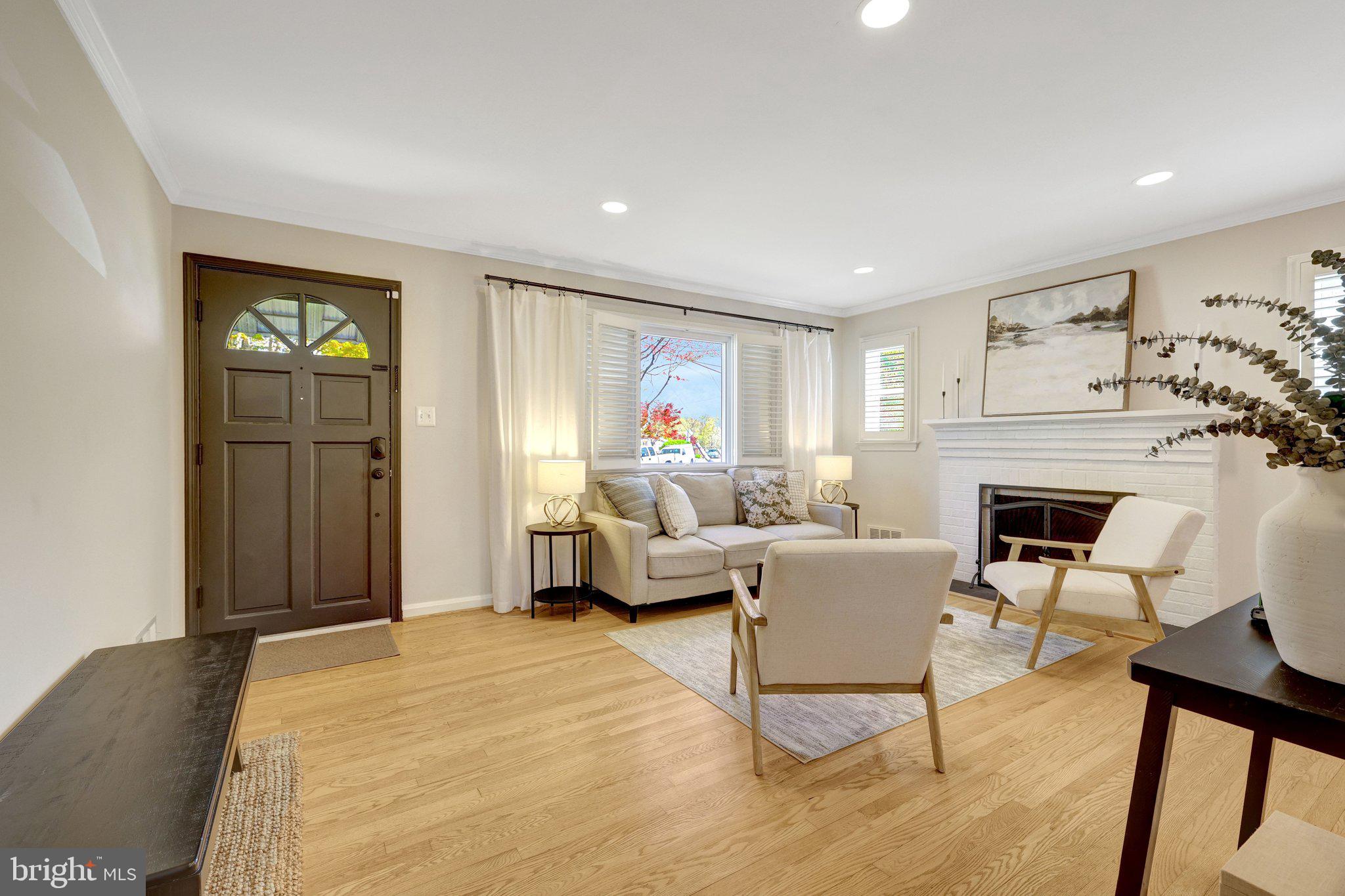 4132 Addison Road Fairfax, VA 22030 - Photo 7 of 58 a living room with furniture a fireplace and a flat screen tv