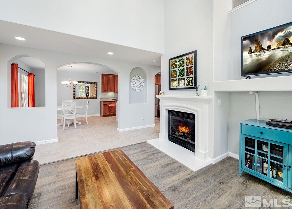 1633 Clover Hill Trail Reno, NV 89523 - Photo 13 of 37 a living room with furniture a flat screen tv and a fireplace