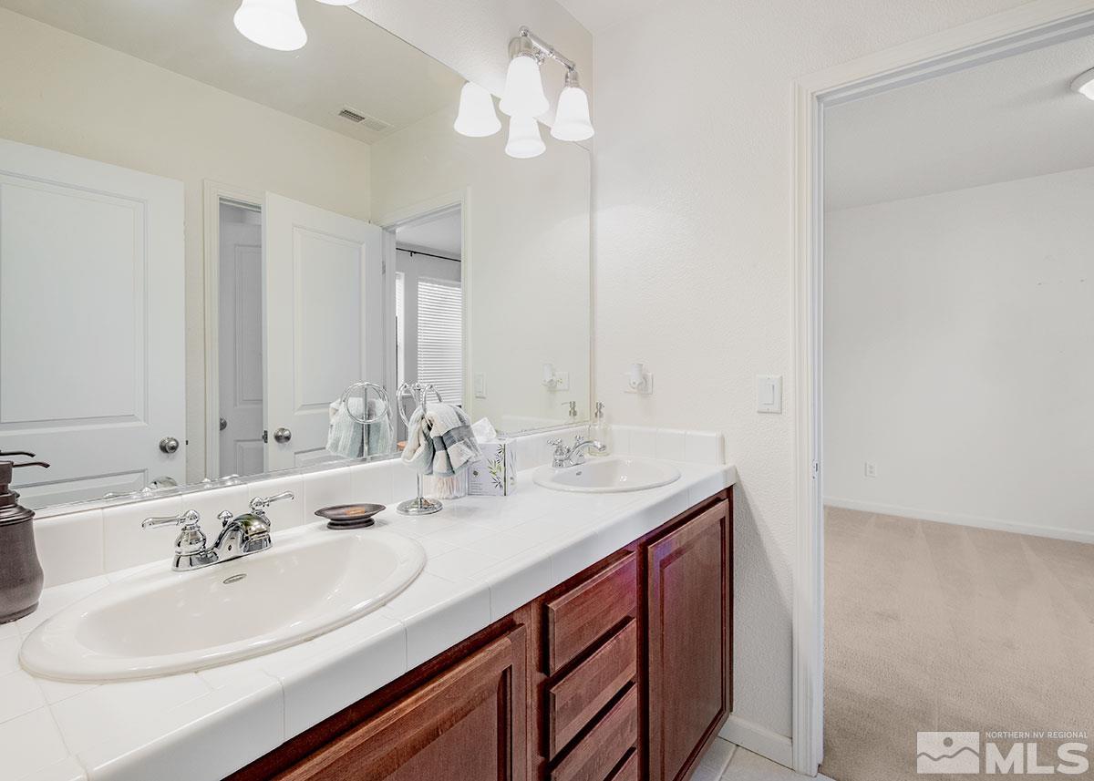 1633 Clover Hill Trail Reno, NV 89523 - Photo 15 of 37 a bathroom with a sink double vanity and a mirror