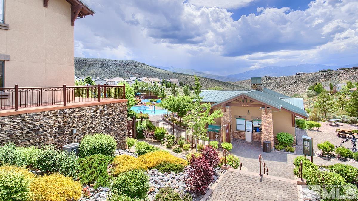 1633 Clover Hill Trail Reno, NV 89523 - Photo 32 of 37 a view of a garden with a lot of flower plants and wooden fence