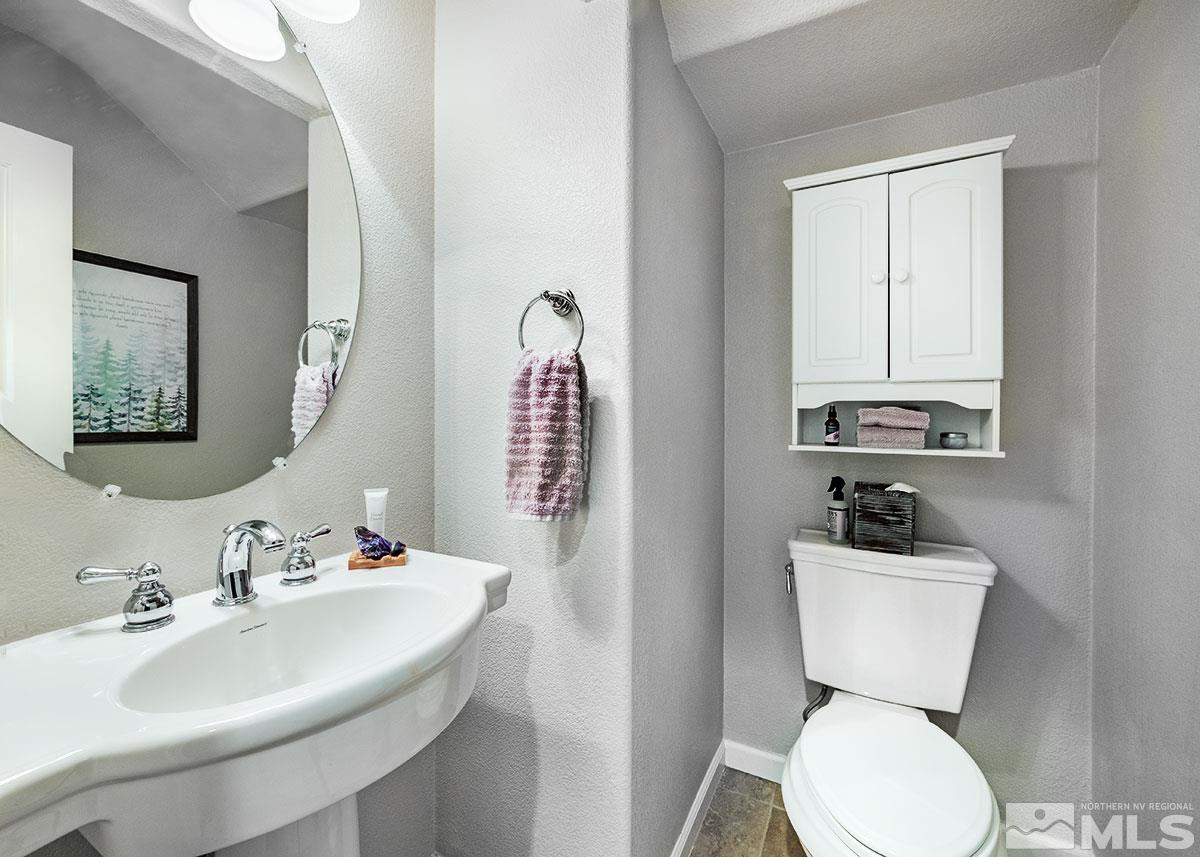 1633 Clover Hill Trail Reno, NV 89523 - Photo 36 of 37 a bathroom with a toilet sink and mirror
