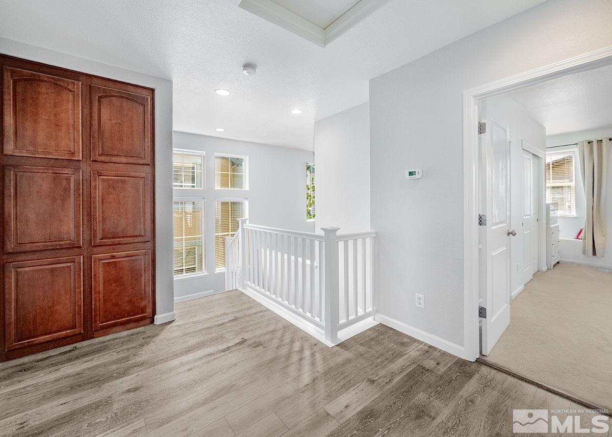 1633 Clover Hill Trail Reno, NV 89523 - Photo 9 of 37 a view of a hallway with wooden floor and cabinet