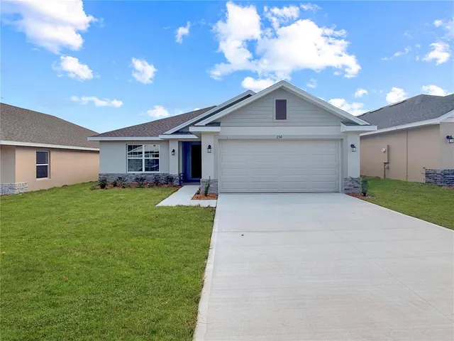 a front view of house with yard and green space