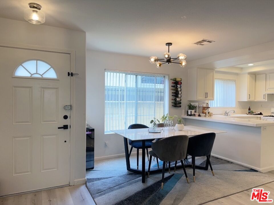 7864 Stewart And Gray Road Downey, CA 90241 - Photo 13 of 25 a dining room with furniture and window