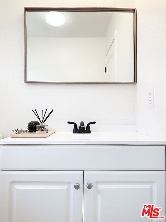 7864 Stewart And Gray Road Downey, CA 90241 - Photo 16 of 25 a bathroom with a sink and a mirror