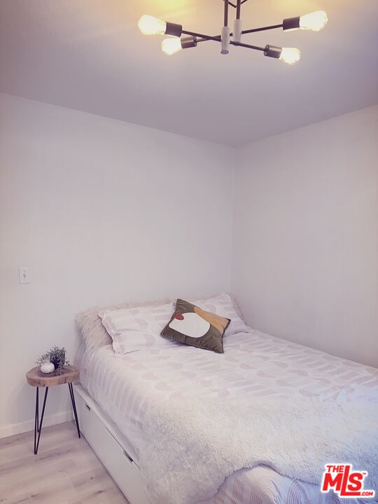 7864 Stewart And Gray Road Downey, CA 90241 - Photo 21 of 25 a bedroom with a bed and chair