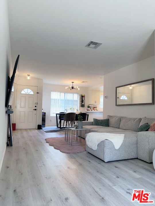 7864 Stewart And Gray Road Downey, CA 90241 - Photo 5 of 25 a living room with furniture and a wooden floor