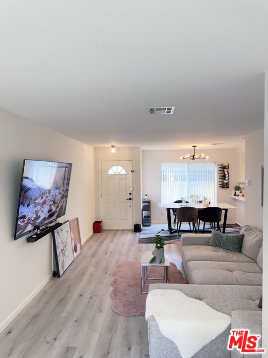 7864 Stewart And Gray Road Downey, CA 90241 - Photo 6 of 25 a living room with furniture and a wooden floor