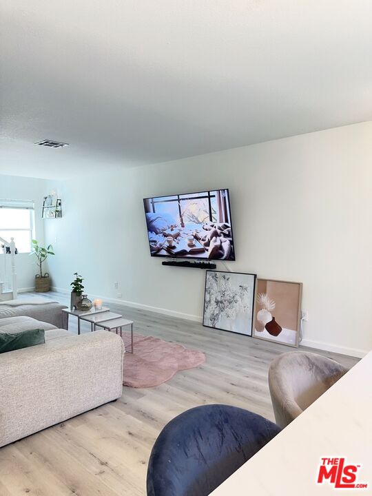 7864 Stewart And Gray Road Downey, CA 90241 - Photo 7 of 25 a living room with furniture and painting on the wall
