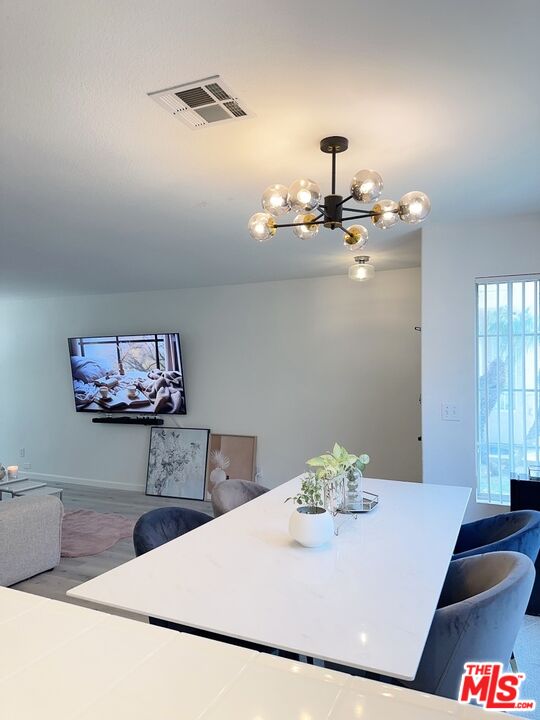 7864 Stewart And Gray Road Downey, CA 90241 - Photo 8 of 25 a kitchen with a table and cabinets