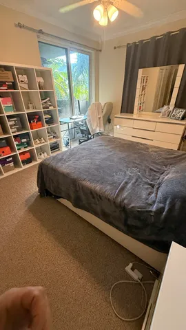 a bedroom with a bed and a window
