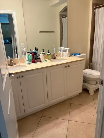 a bathroom with a sink toilet and mirror