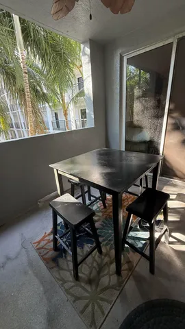 a view of a workspace with furniture and window