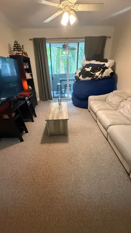 a bed room with furniture and a flat screen tv