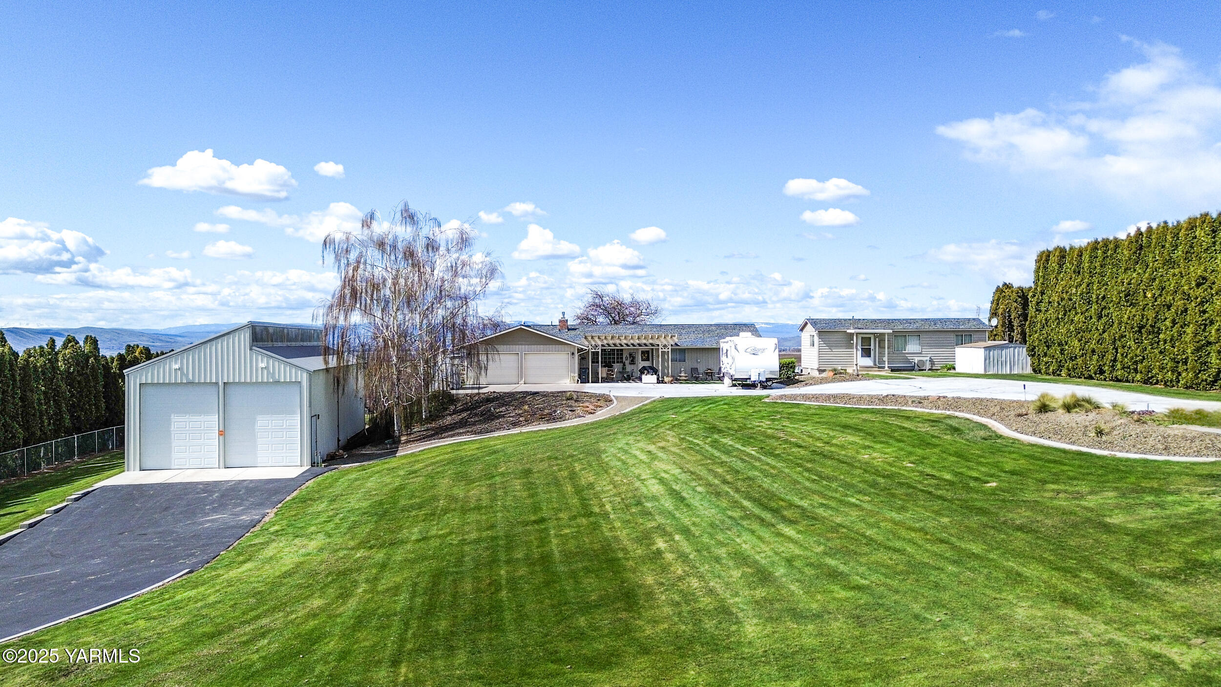 1682 St Hilaire Road Yakima, WA 98901 - Photo 3 of 51 a view of a house with a yard porch and sitting area