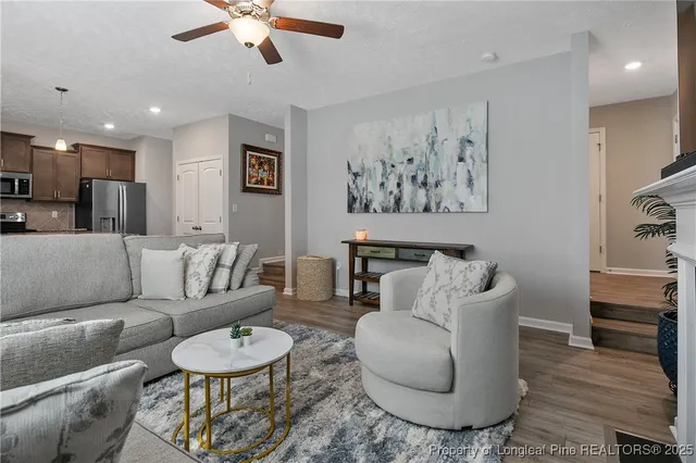 a living room with furniture and a wooden floor