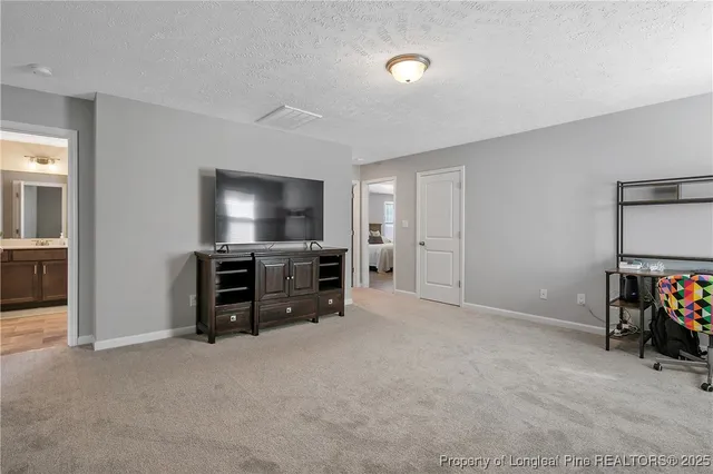 a view of a livingroom with furniture and a flat screen tv