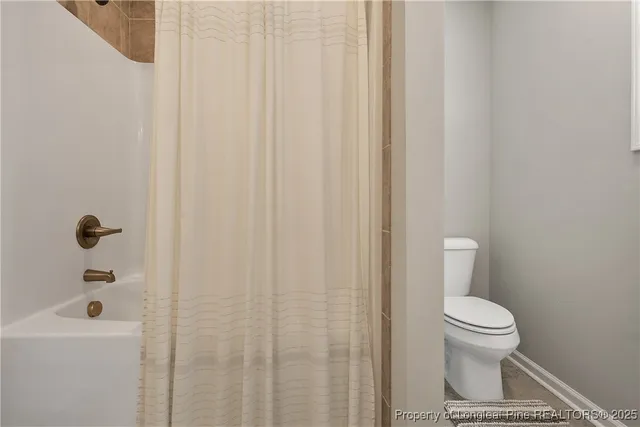 a bathroom with a toilet and a bathtub