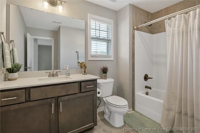 a bathroom with a sink toilet a shower and a mirror
