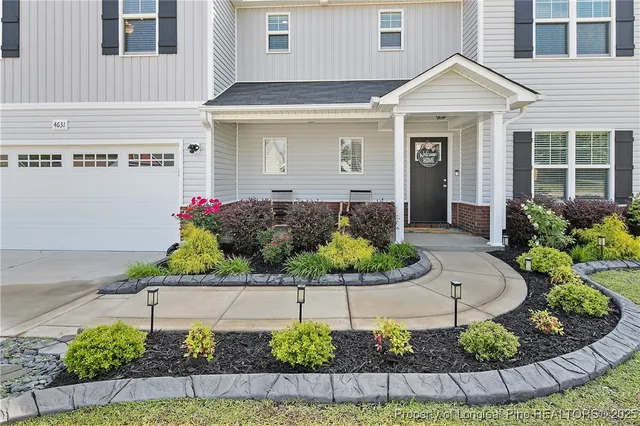 a front view of a house with a garden