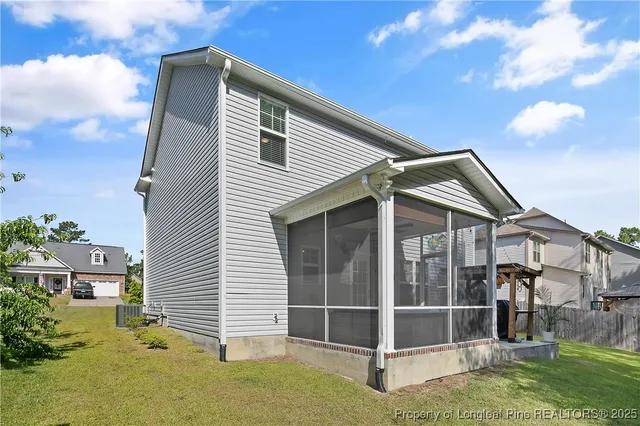 a view of a house with a yard and sitting area